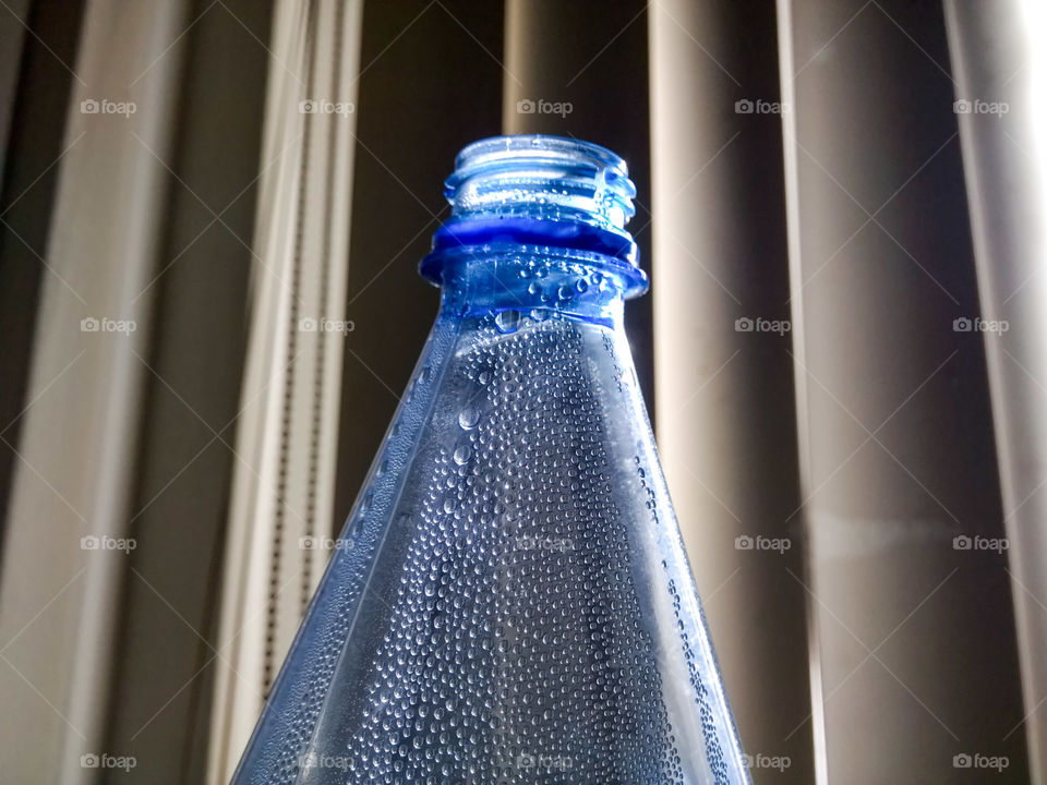 Water bottle with water droplets on the side of the bottle.