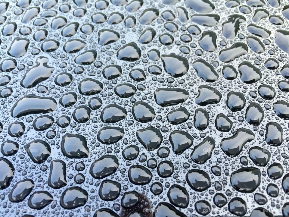 Water droplets on a smoked glass table