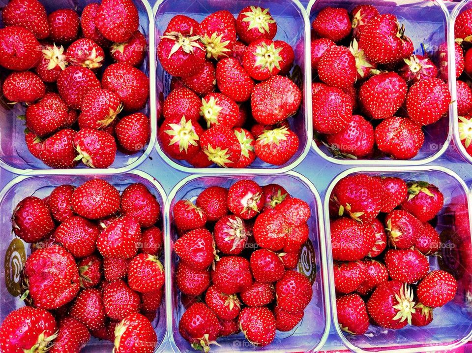 Boxes with strawberries for sale at farmers market.