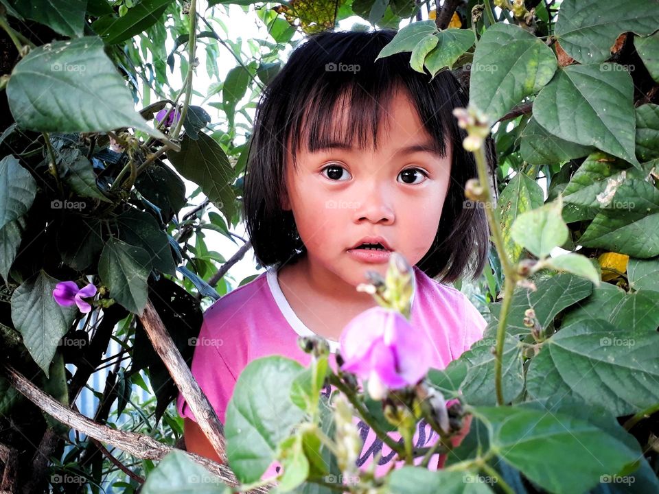 Portrait of a little girl, lost in nature