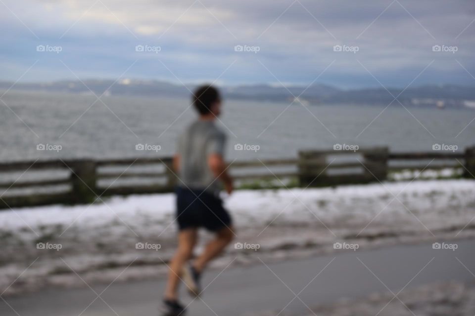 Man running by the ocean 