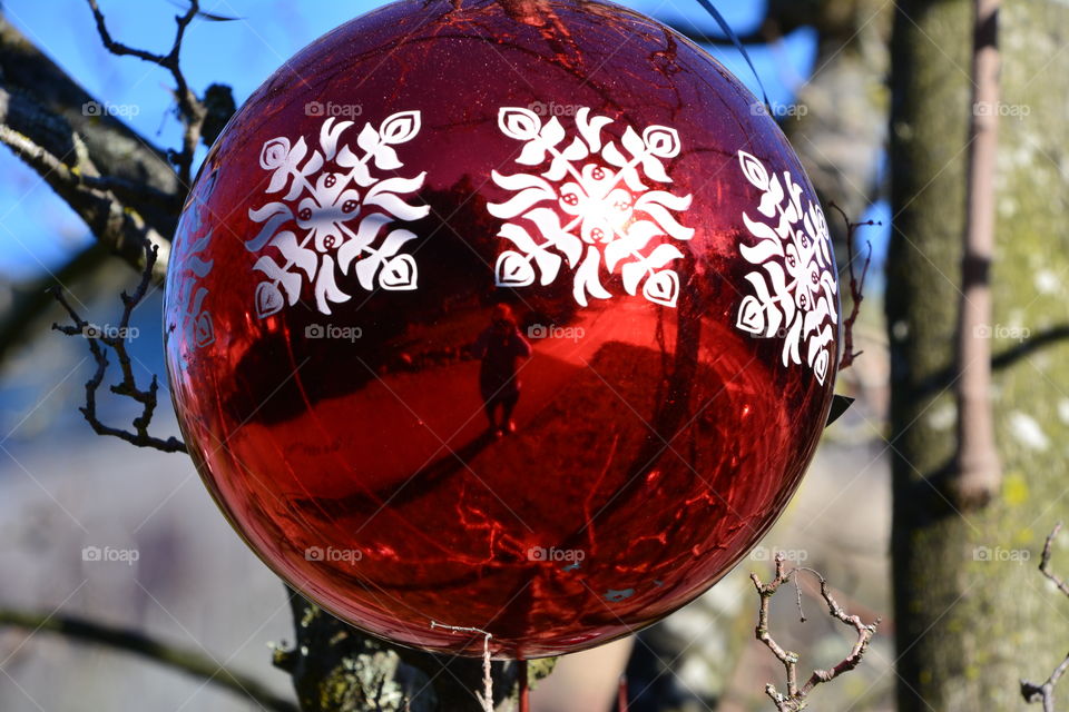 Photographer reflected in outdoor ornament 