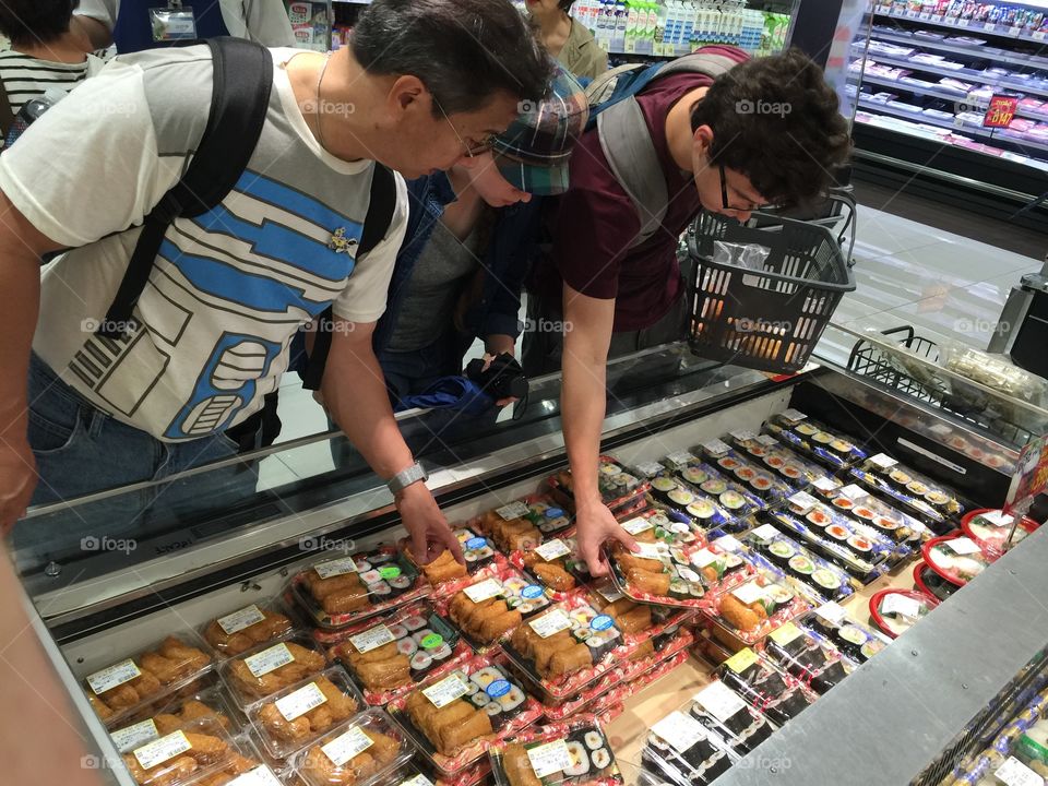 Shopping for sushi in Japanese grocery store 