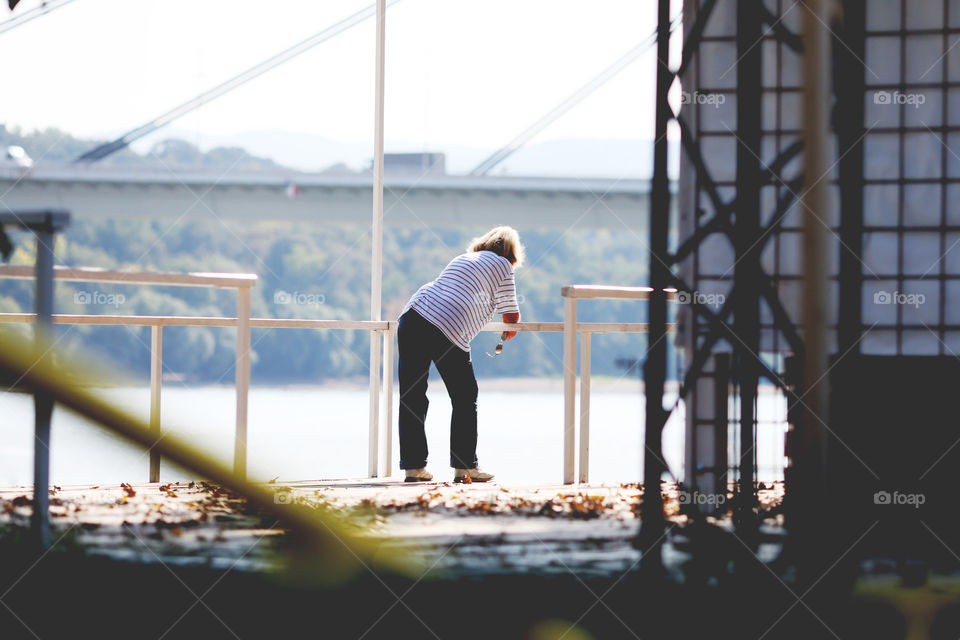 Elder woman enjoying the view from a terrace