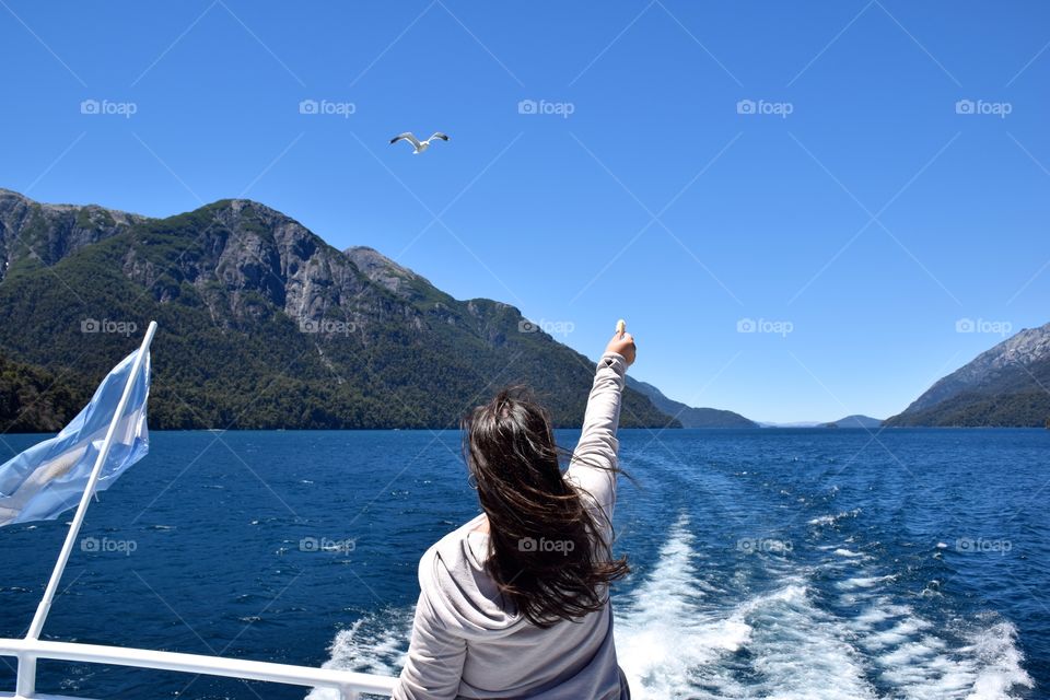 Woman feeding birds on a boat