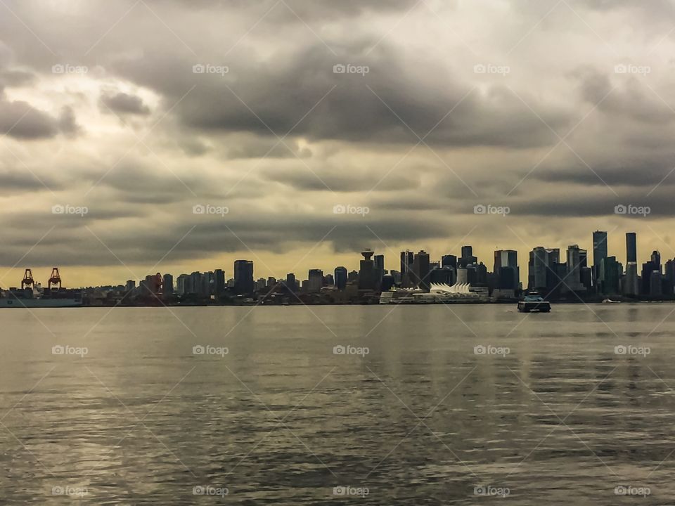 View of downtown Vancouver from Londsale Quay on a cloudy day in North Vancouver, British Columbia 