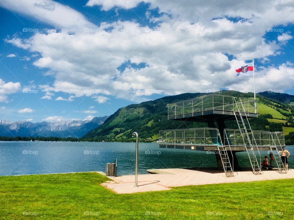 The swim tower at alpine lake with mountains behind 