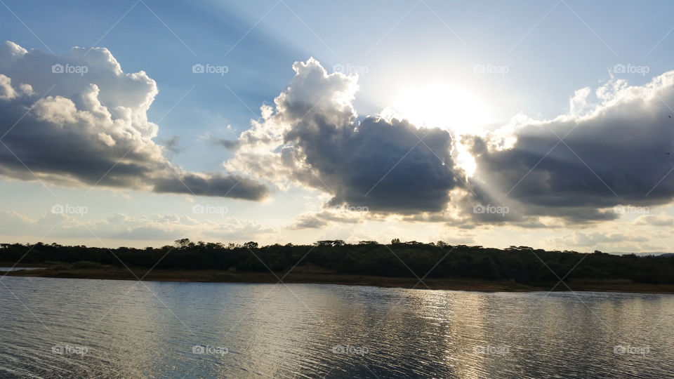 sun behind clouds showing some rays