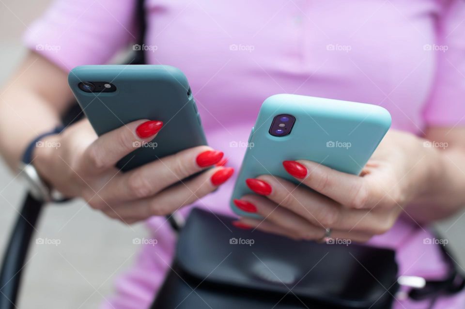 Business woman holding phones