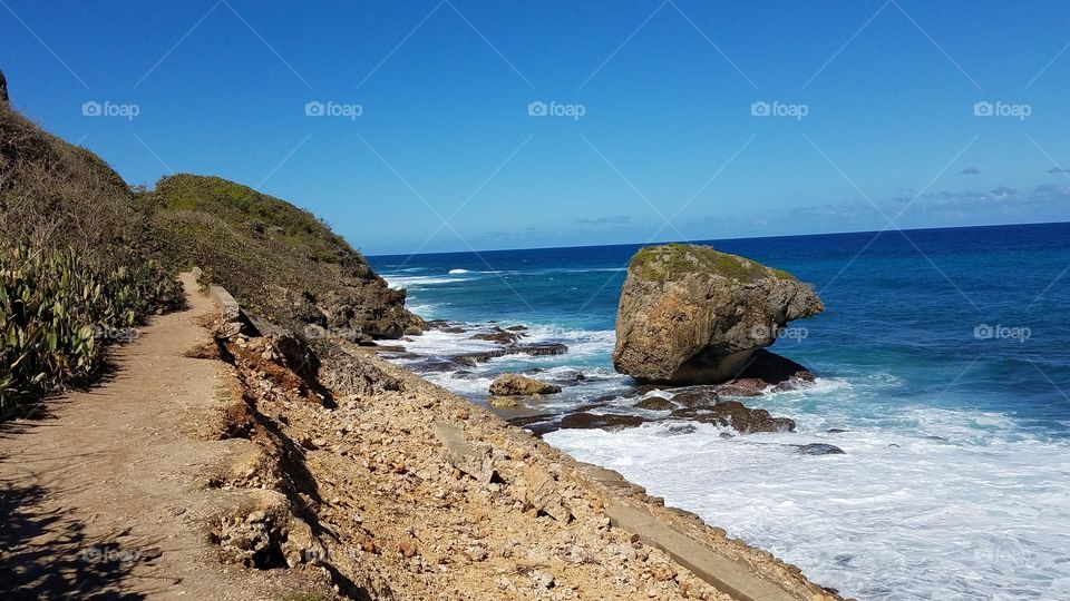 beautiful turquoise ocean of western Puerto Rico showing waves crashing along the rocky coastline