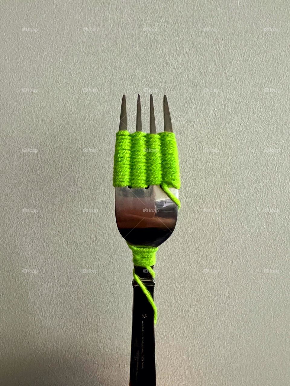 A fork with woolen yarn.