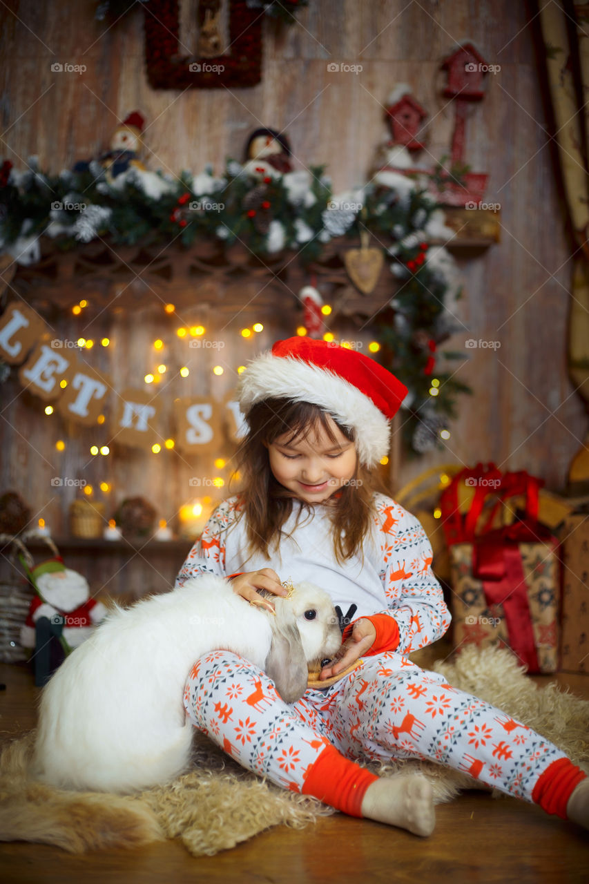 Little sisters near fireplace at Christmas Eve 