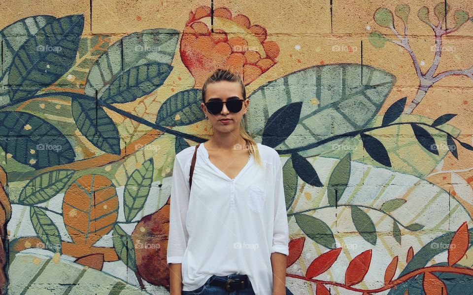 a girl and a graffiti wall