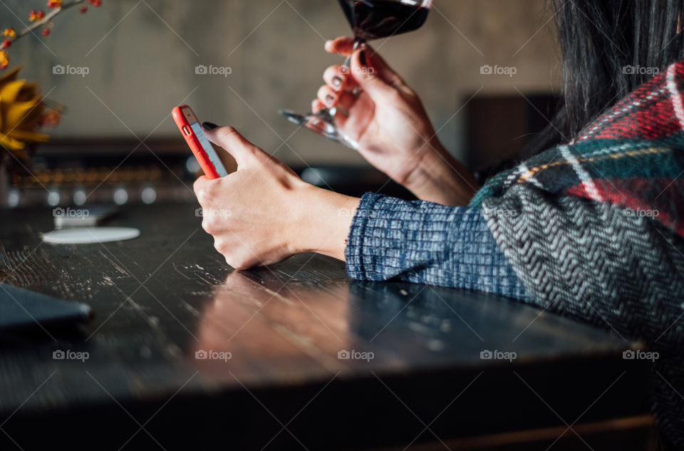 Woman using banking and drinking red wine 