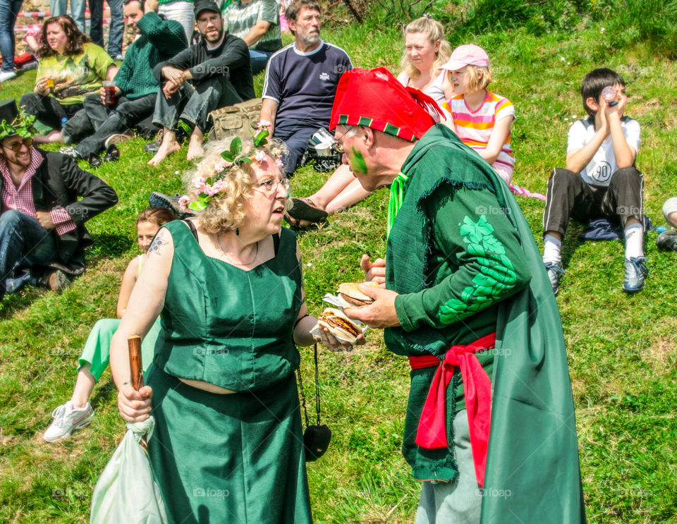 A couple enjoy a snack and a chat, whilst in costume at Hastings Traditional Jack in the Green, U.K. 2008