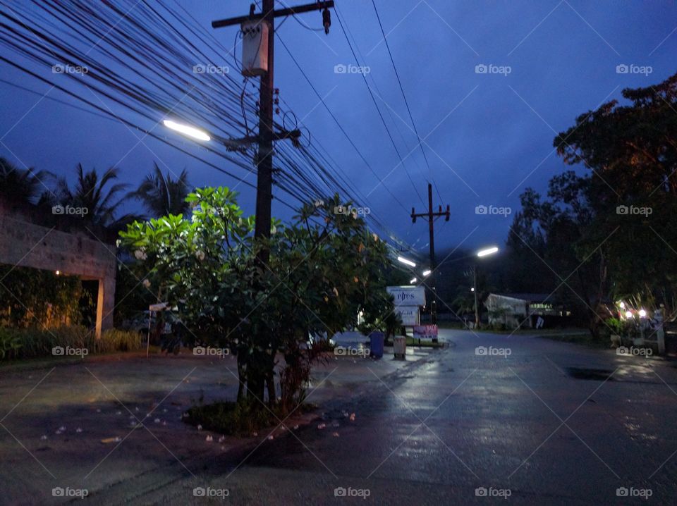a street in phuket during the night with bright street lights