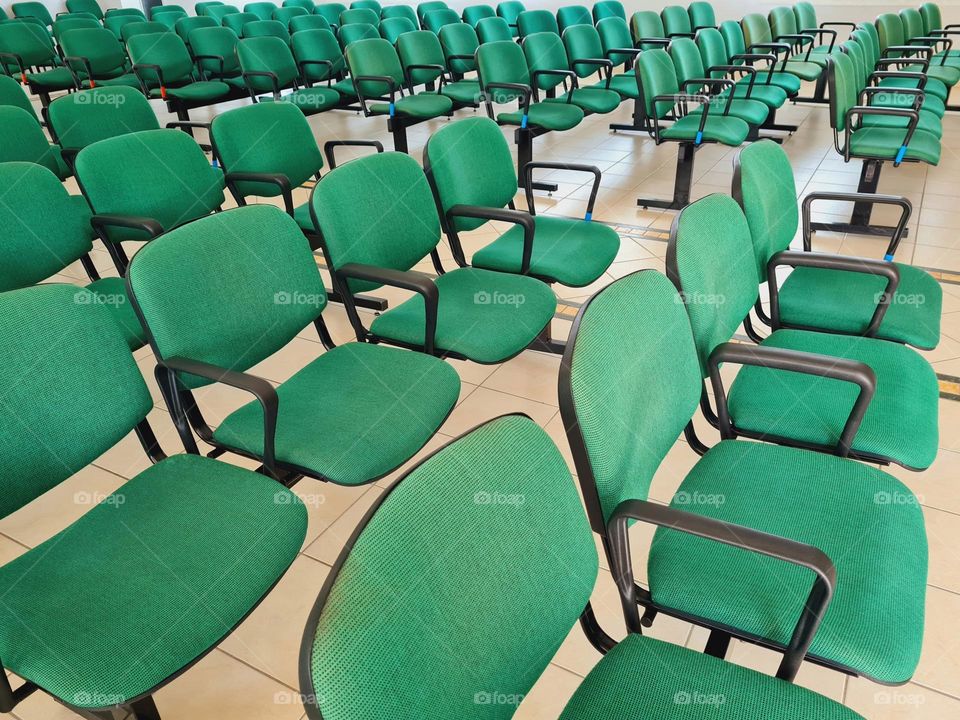 expanse of green upholstered chairs in a row