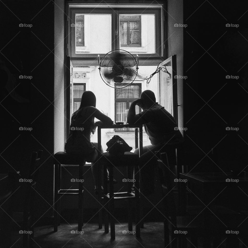 Couple looking out through the window
