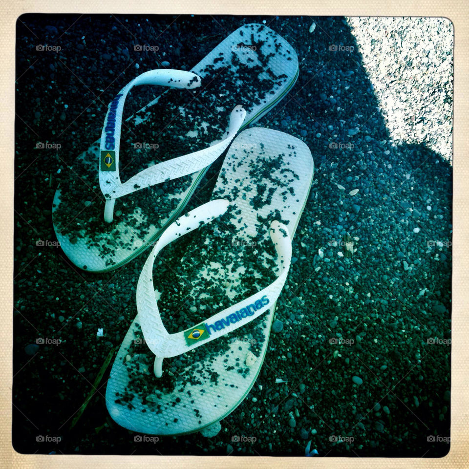 White havianas flip flops on the beach