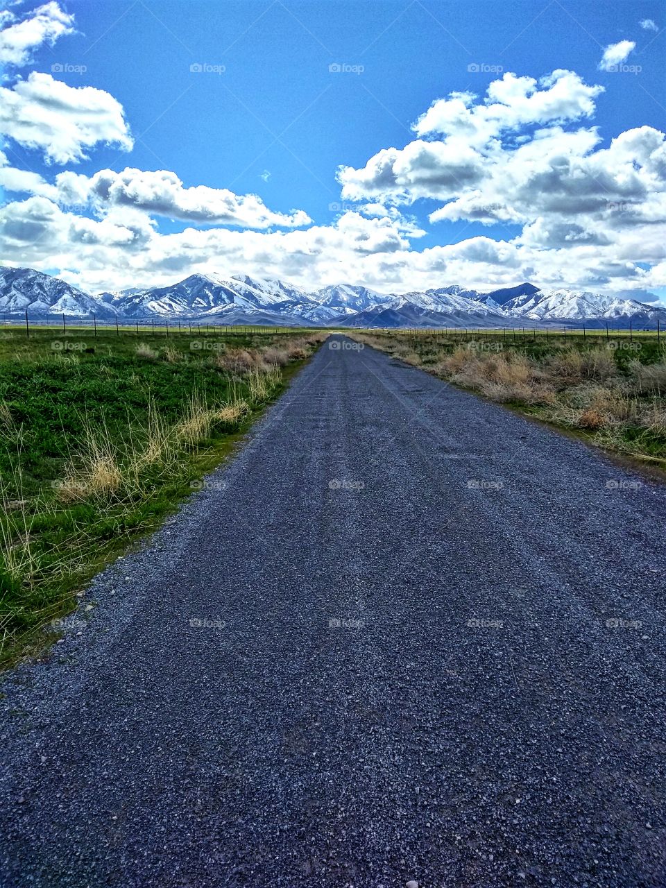 road leading to snowy Utah mountains