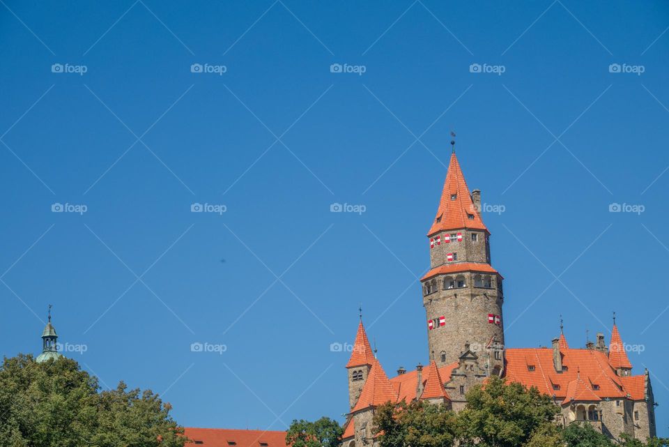 The famous Czech castle Bouzov with a typical roof and shutters.