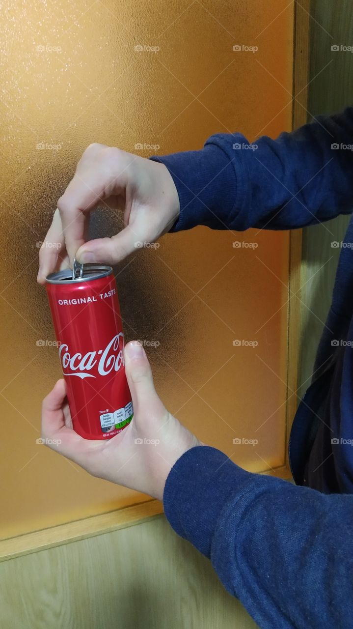 opening a Coca Cola can