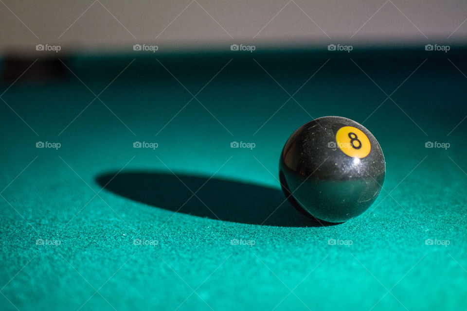 An eight ball on a pool table