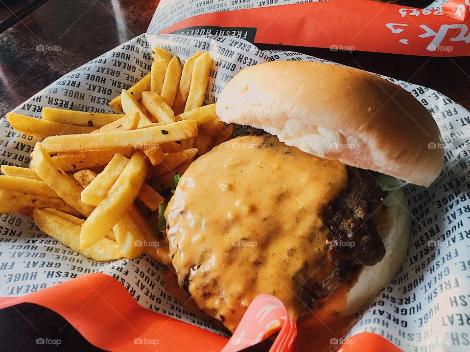 Cheese burger melt with fries on the side.