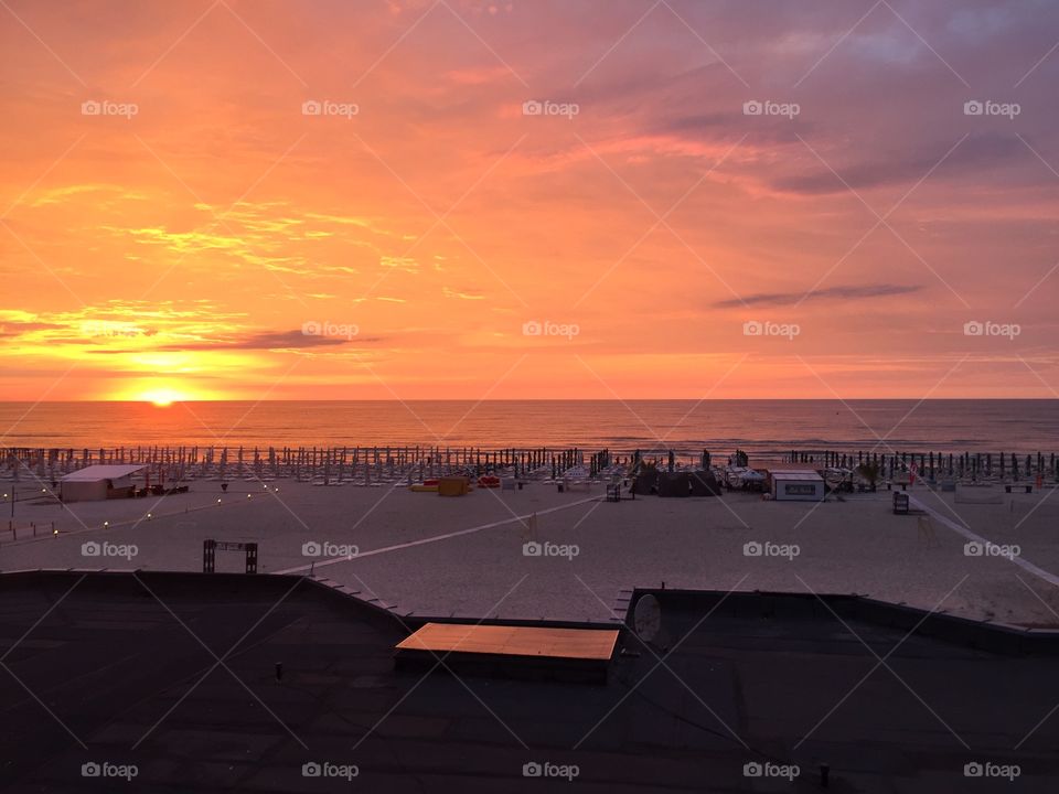 Bright orange sunrise at the sea seen from the hotel room