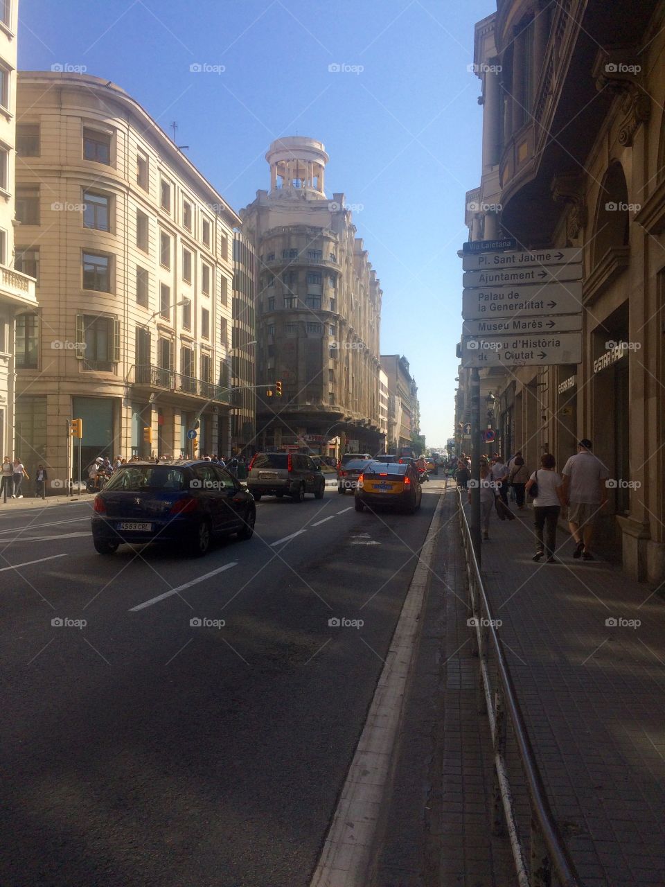 Street view of a busy daytime scene in Barcelona city centre in Spain on a sunny Autumn day