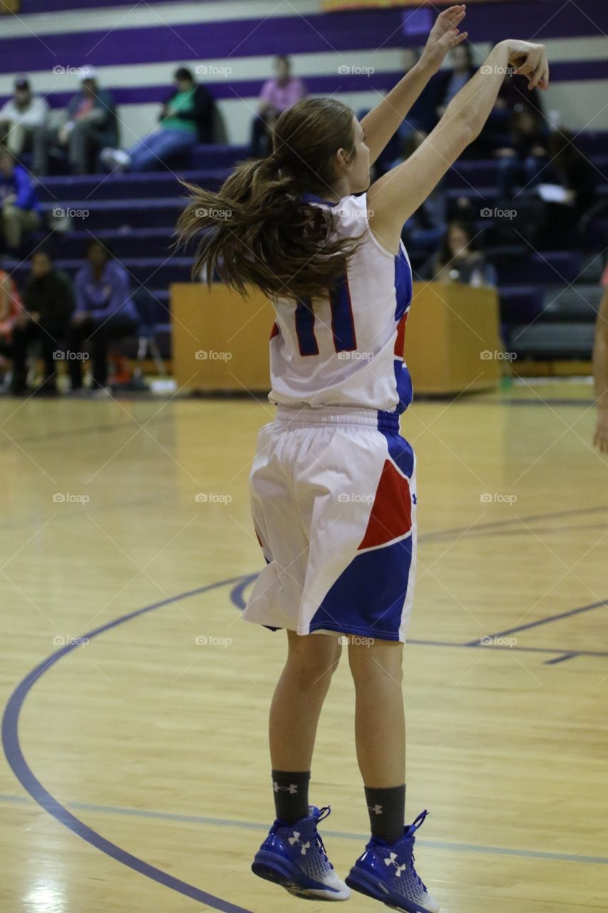 Beautiful form as she shoots the basketball at home as number eleven.
