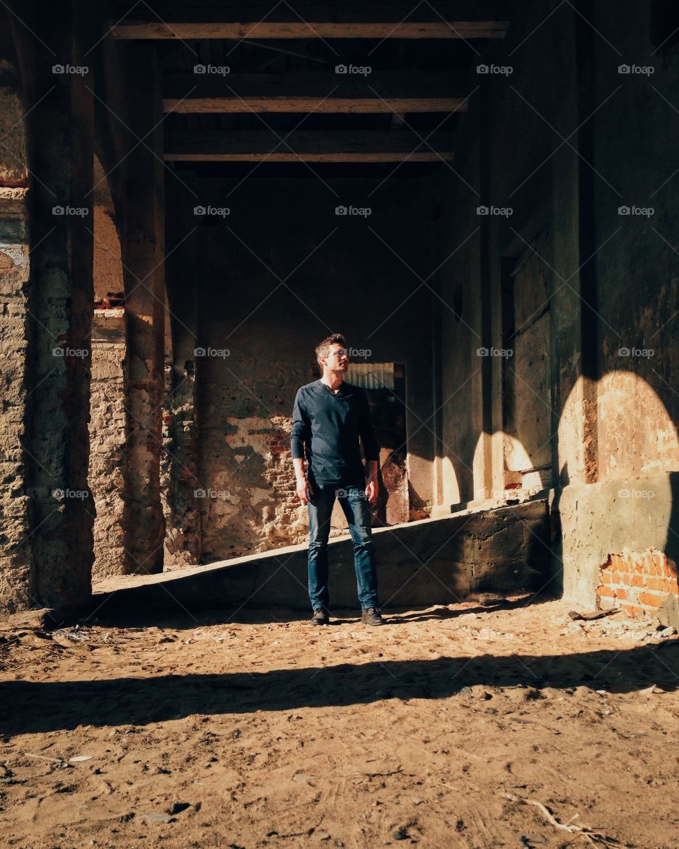 Man standing in old ruin building