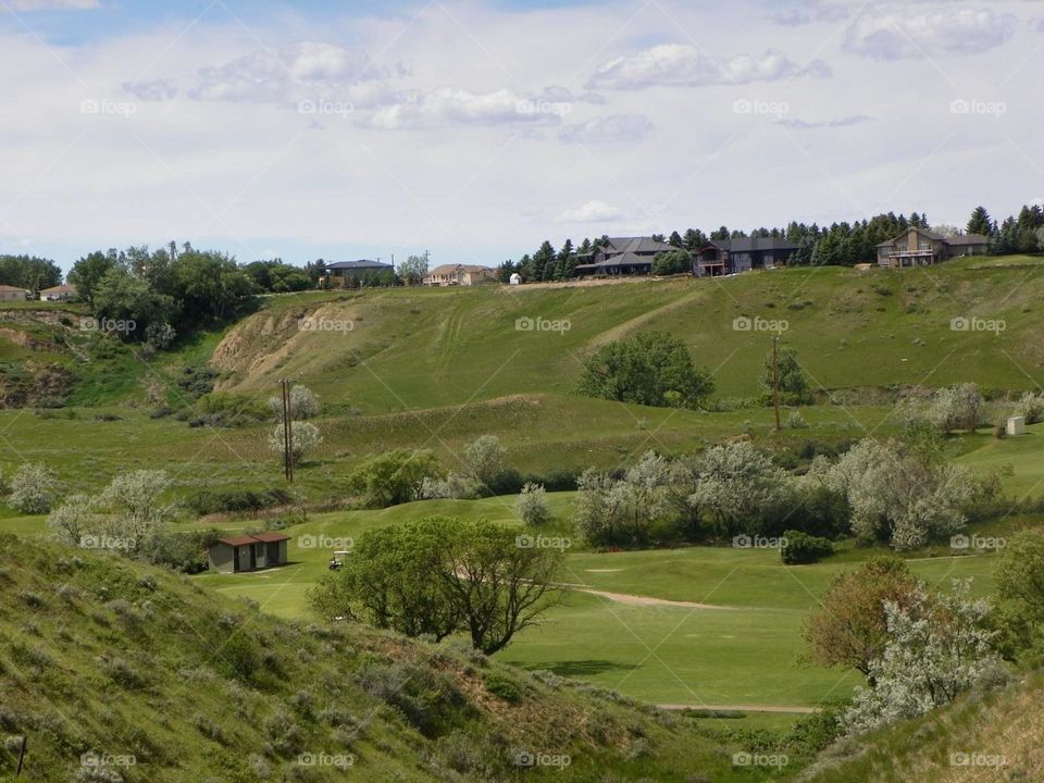 This is a beautiful, lush green landscape picture, of a golf course in the coulees on a sunny day, in Medicine Hat, Alberta, Canada