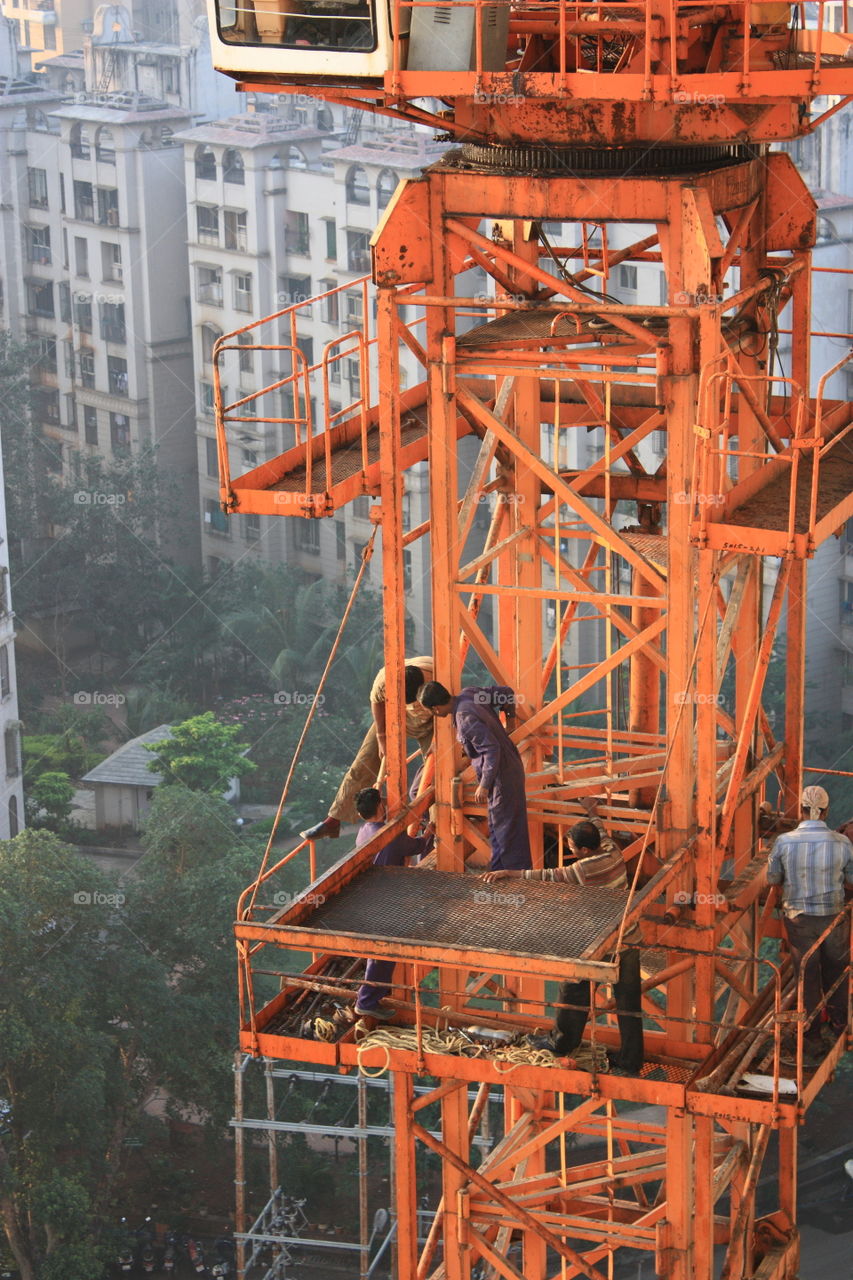 men at work on a crane