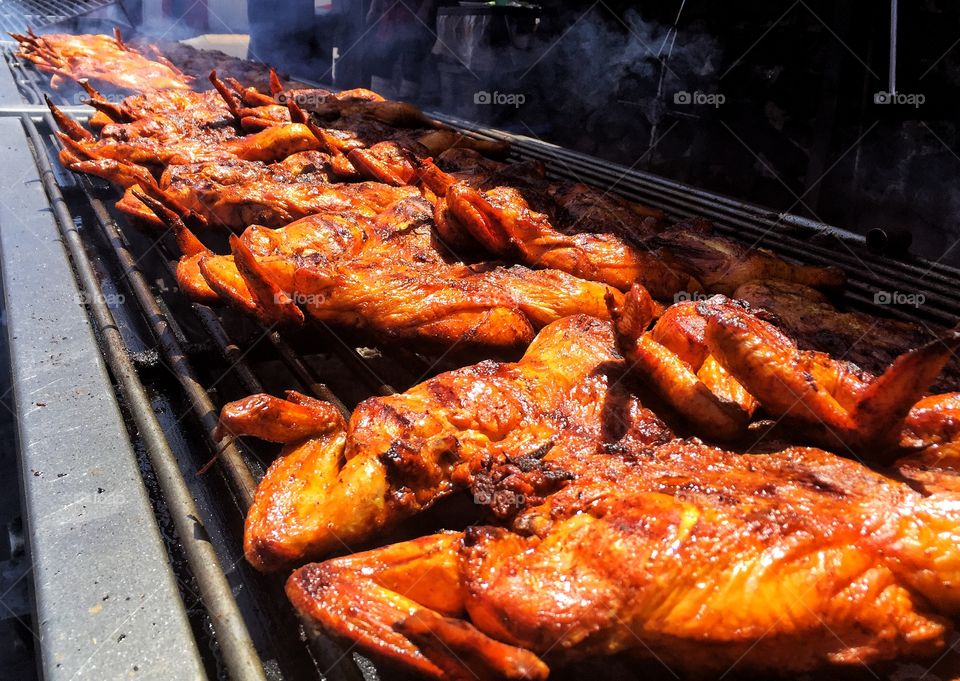 Chicken being cooked on barbecue grill