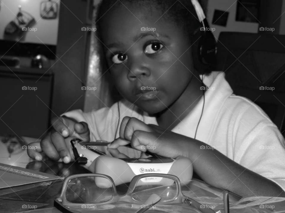 A monochrome picture of a child using the educational tool "Nabi" to learn while having fun