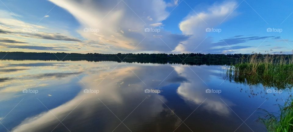 the reflection of the sky's in the water look like a bird's wing