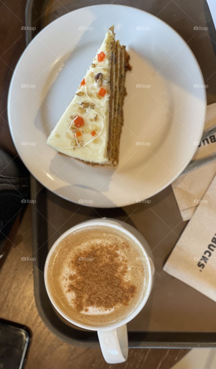 Carrot cake beside Cappuccino 