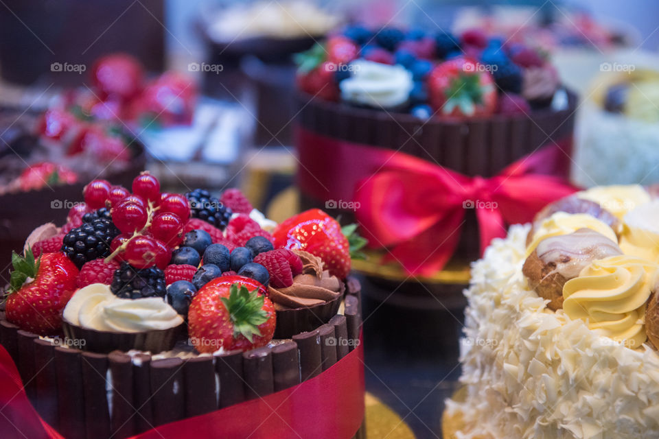 exclusive cakes with blueberries, strawberries and chocolate in a shop in London.