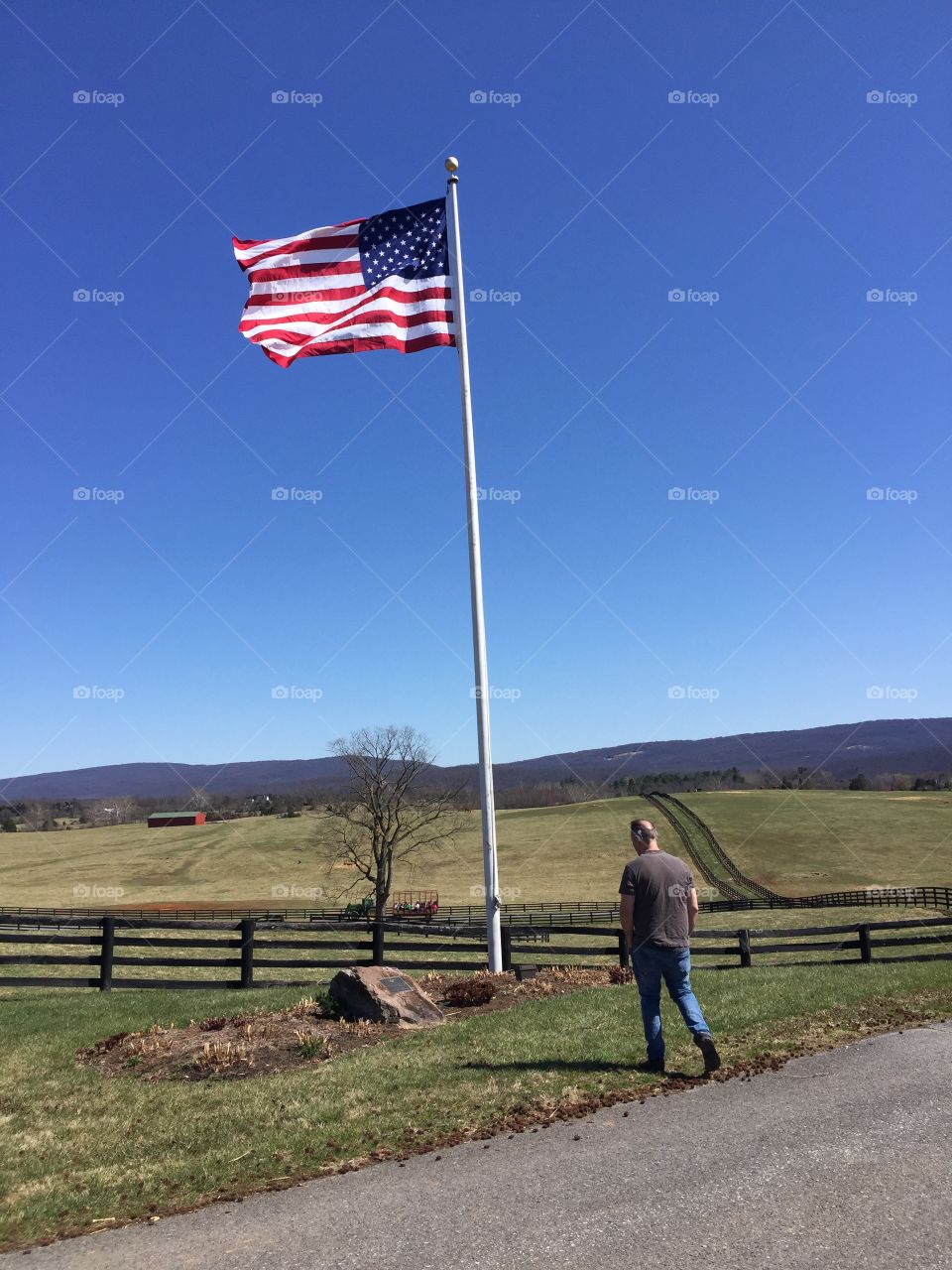 A proud American walking to his proud flag 