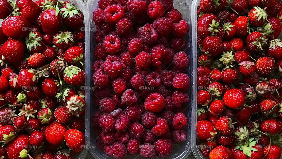 Fresh red ripe strawberries and raspberries 