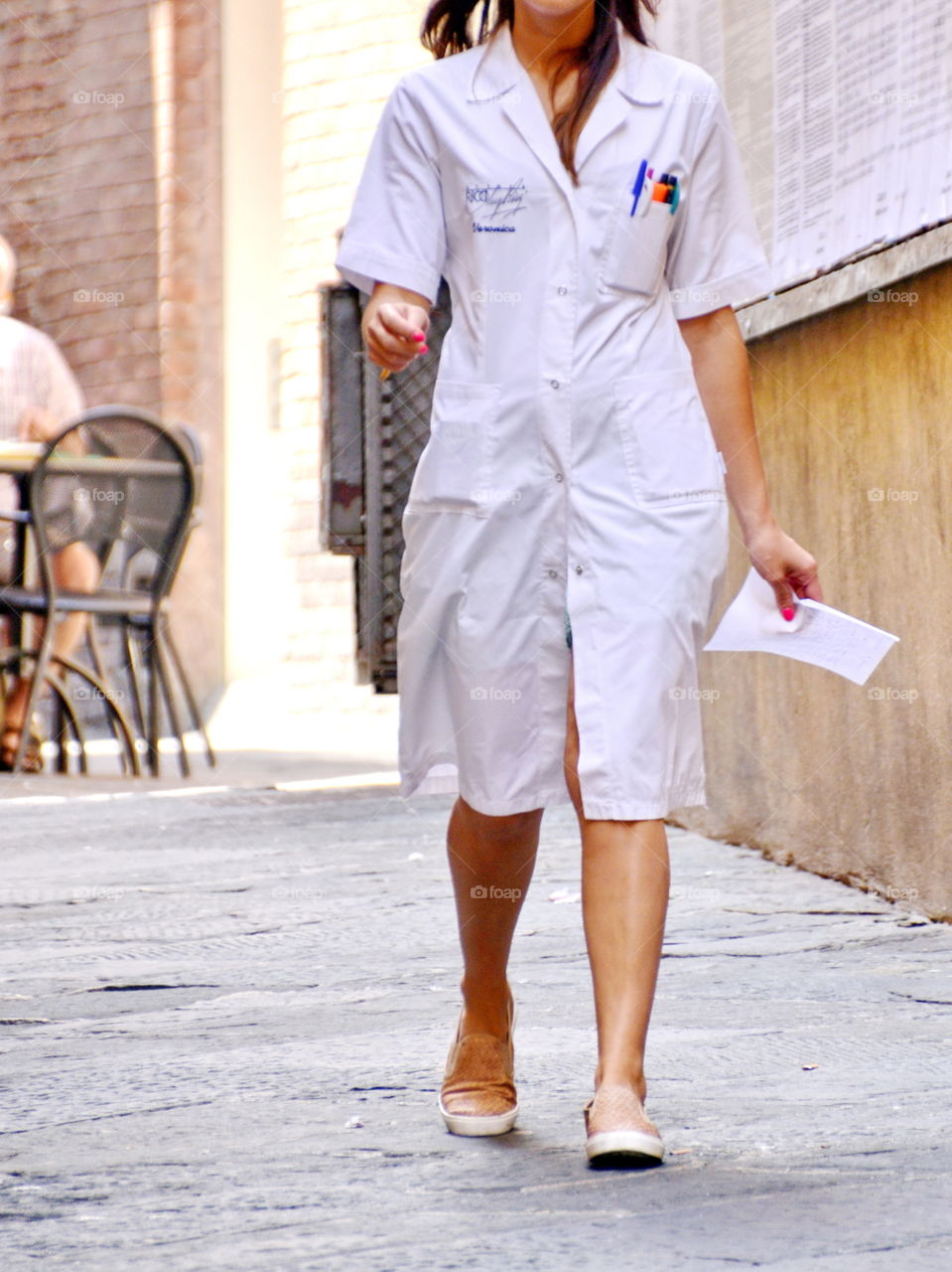 a young woman with work shirts walking in the street