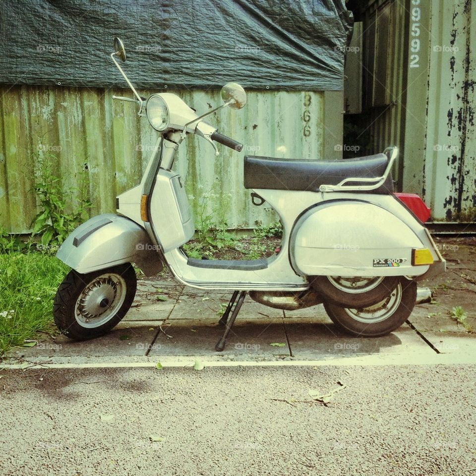 Silver Vespa px200e scooter.