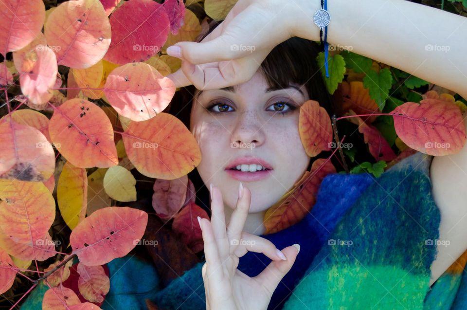 Portrait of a woman brunette on autumn background