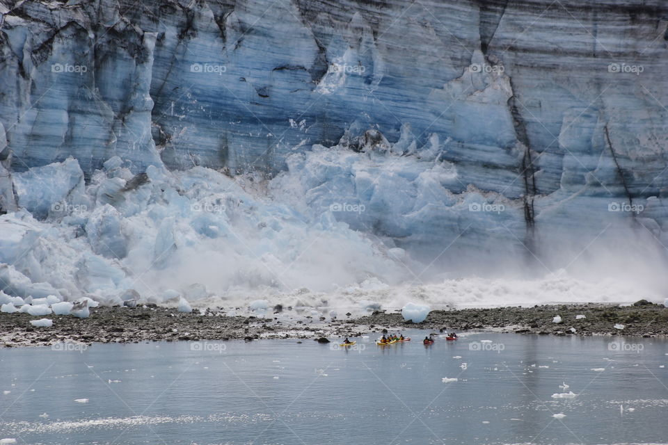 Glacier calving in front of kayakers!