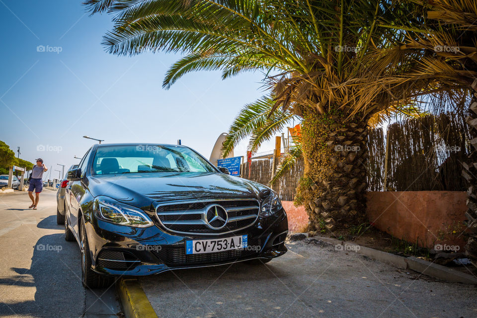 Mercedes Benz in France. A Mercedes parked on the coast, 20 feet from the water, in Hyéres, France