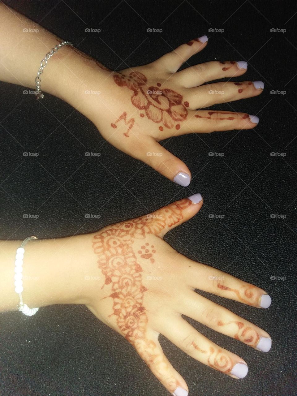 Two beautiful hands decorated by henna.