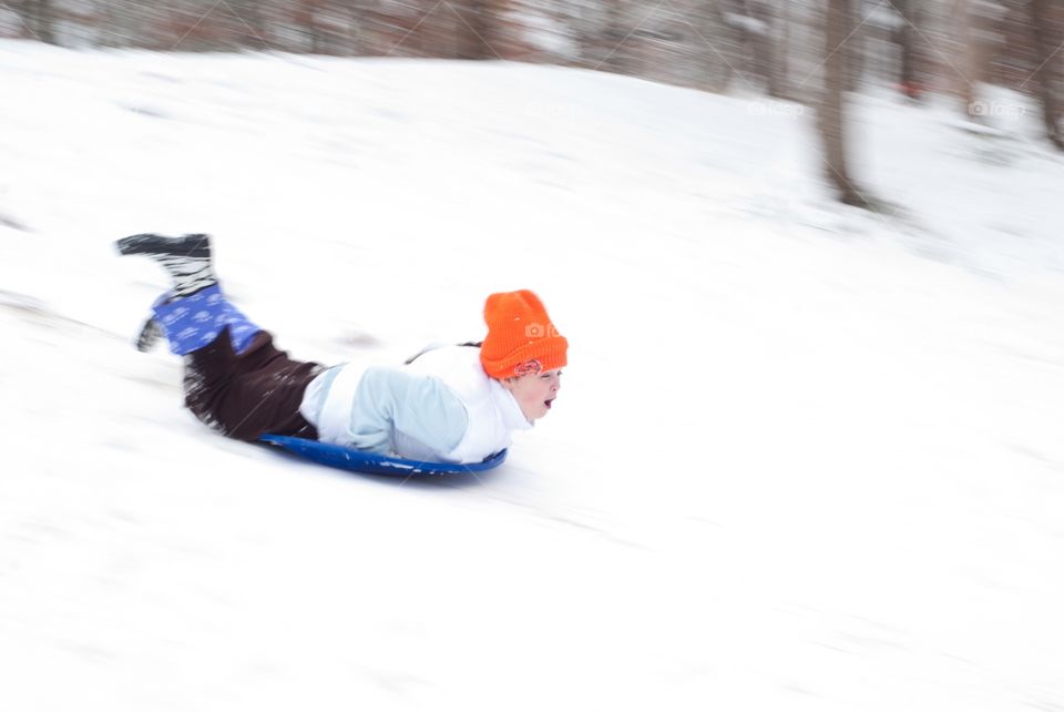 Boy Enjoying On Snowboard