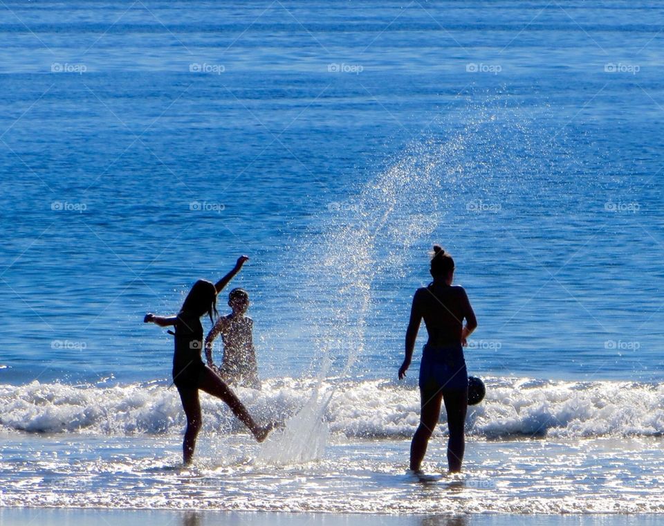 Water Play. Kids playing in surf 