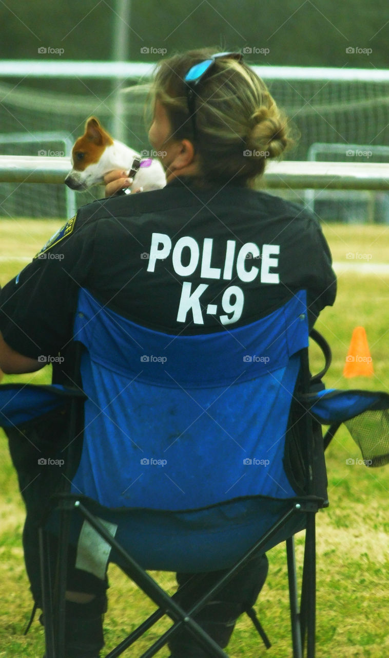 "Size Counts"!
This is a pint-sized K-9 dog with his master is watching an annual K-9 demonstration!
